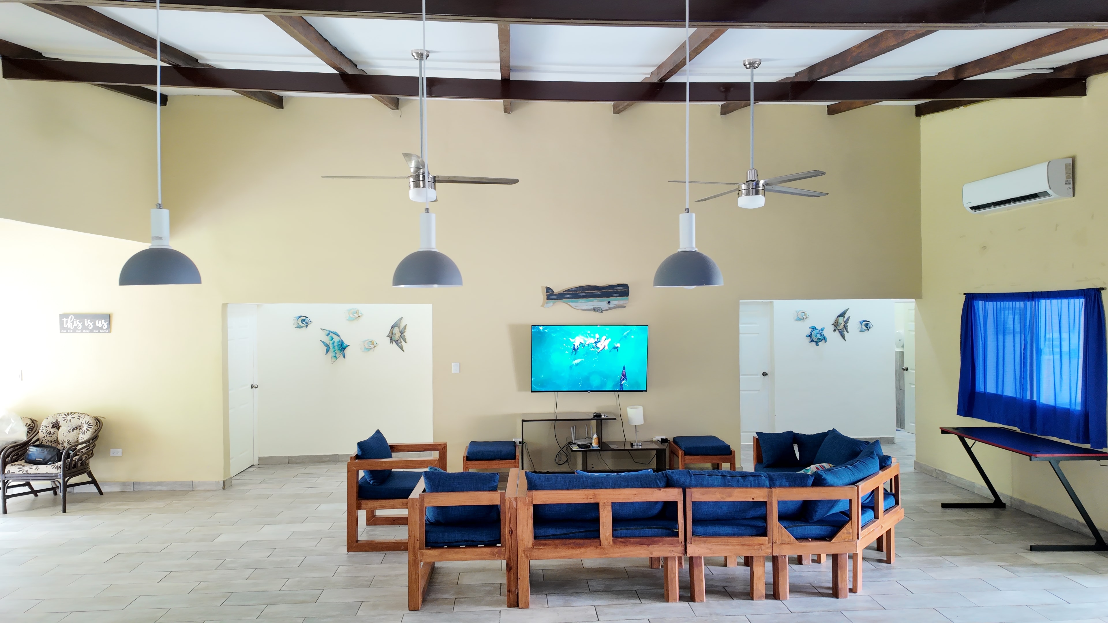 Living room with coastal decor and wood-beam ceiling
